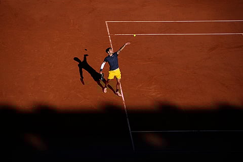 Carlos Alcaraz serves against Italy's Jannik Sinner